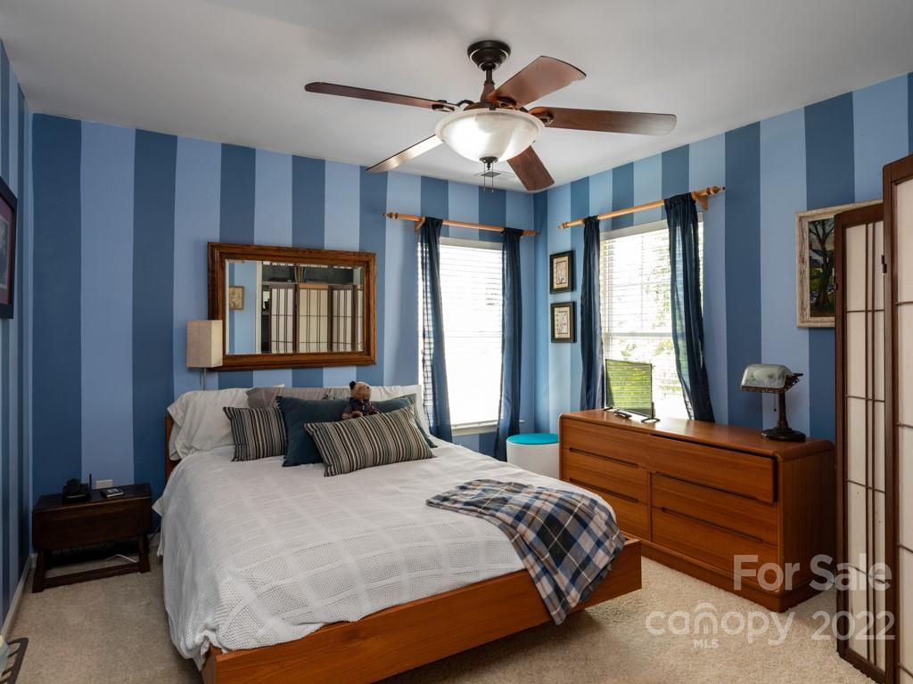 392 Sand Paver Way Fort Mill, SC 29708 - Photo 17 of 35 a bedroom with a large bed and a chandelier