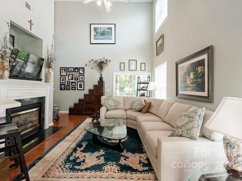 392 Sand Paver Way Fort Mill, SC 29708 - Photo 2 of 35 a living room with furniture a flat screen tv and a fireplace