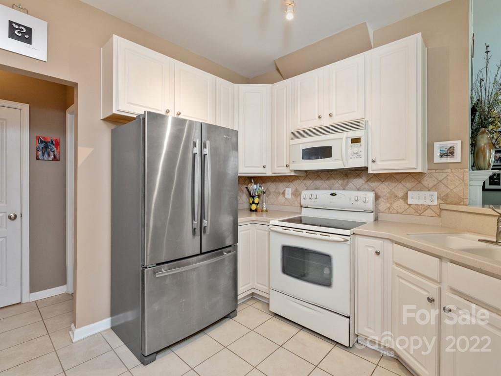 392 Sand Paver Way Fort Mill, SC 29708 - Photo 7 of 35 a kitchen with cabinets stainless steel appliances and a counter space