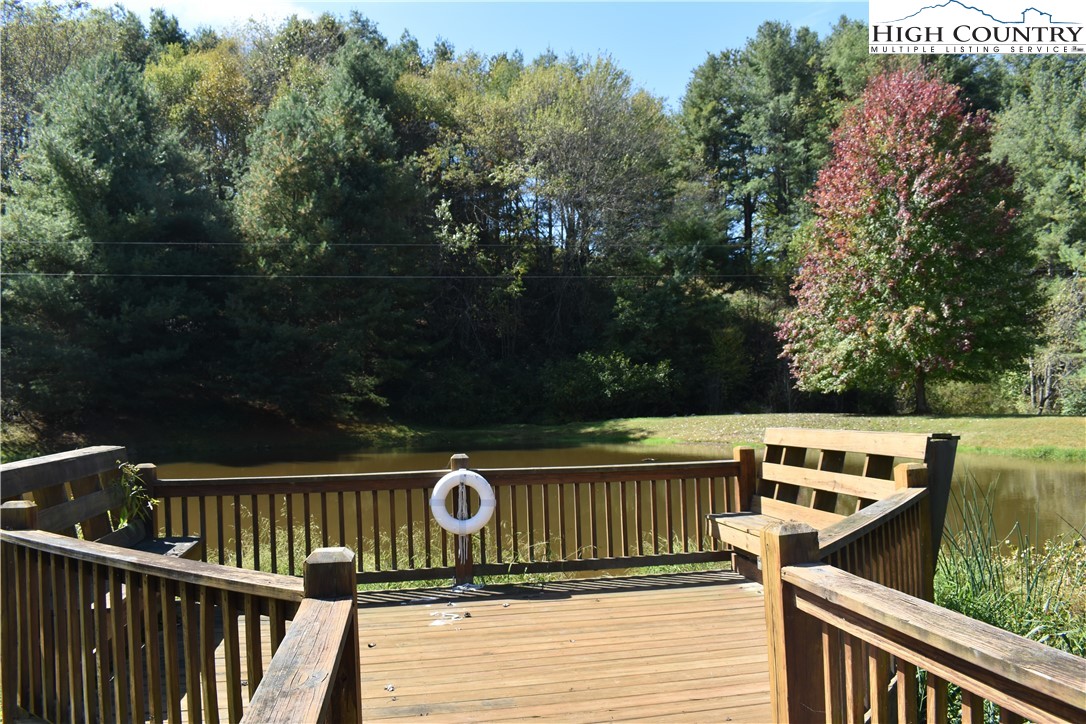 46 Bear Xing Road Sparta, NC 28675 - Photo 12 of 18 a view of a roof deck with wooden floor and fence