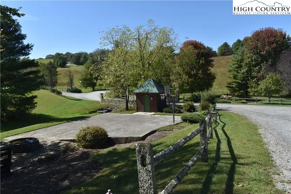 a view of outdoor space with green field and trees all around