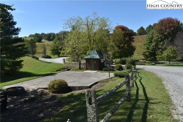 a view of outdoor space with green field and trees all around