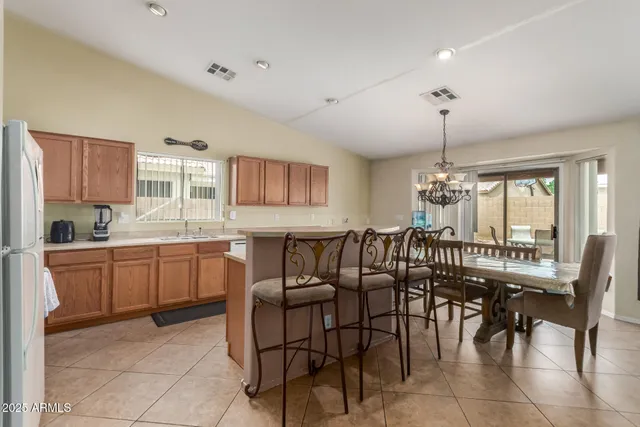 a large kitchen with a table and chairs