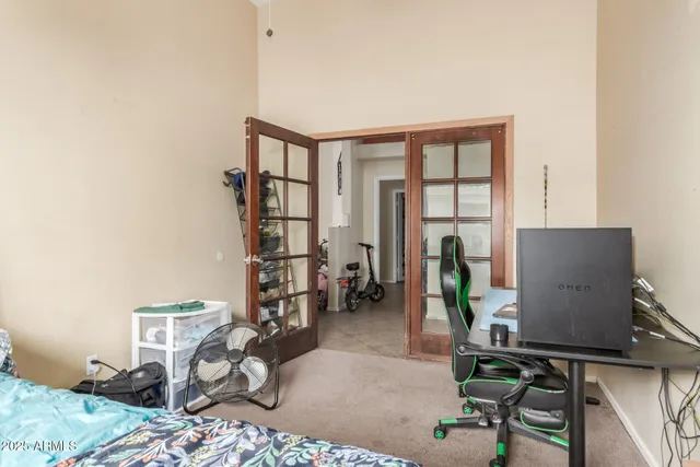 a bedroom with bed tv and window