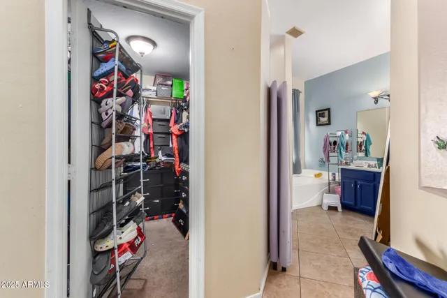 a bedroom with furniture and a flat screen tv