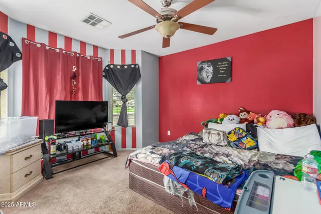 a bedroom with furniture and a window