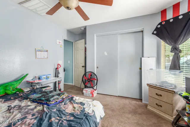 a view of a room with toys and a ceiling fan