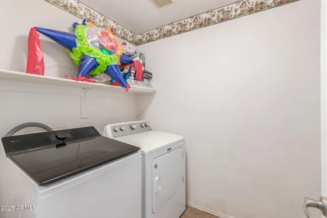 a view of a patio with table and chairs and potted plants