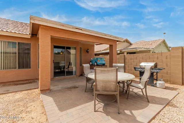 a view of a house with backyard and sitting area