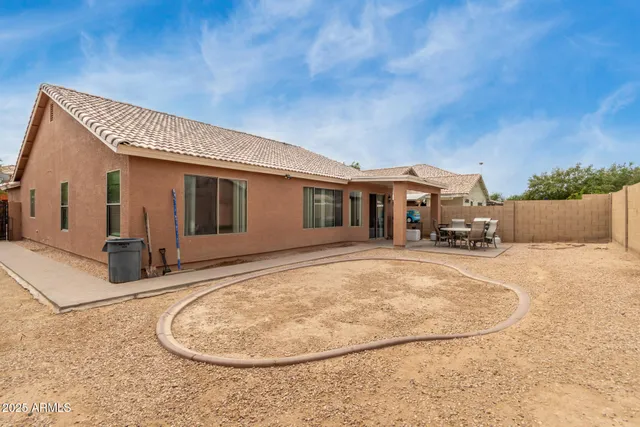 a view of a house with a backyard
