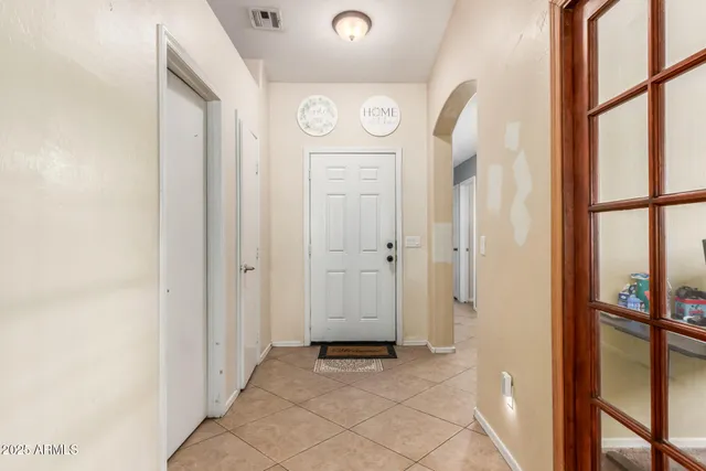 a view of a hallway with windows and entryway