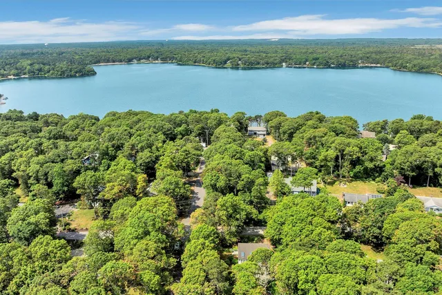 a view of a lake with houses in the back