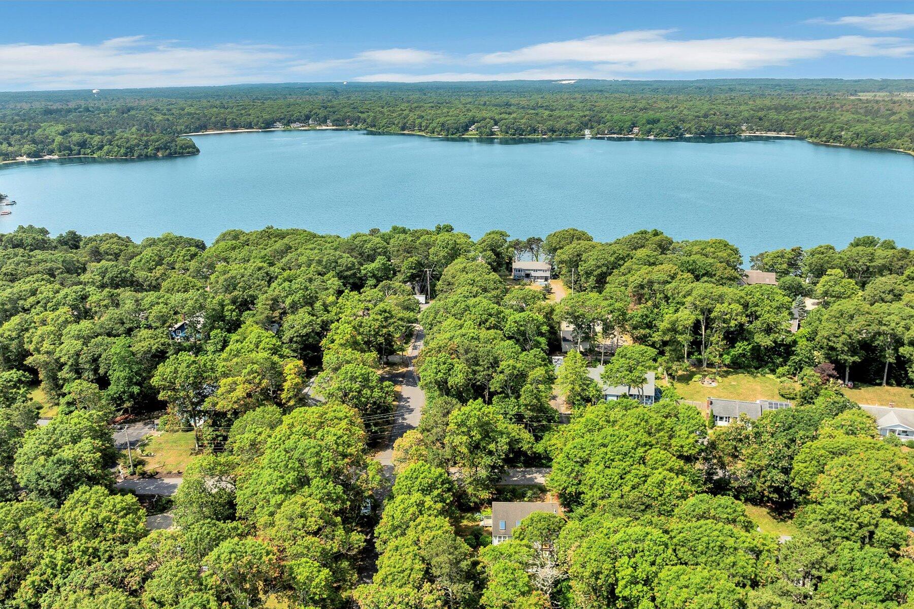 66 Highland Street Mashpee, MA 02649 - Photo 8 of 9 a view of a lake with houses in the back