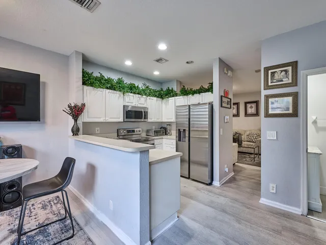 a kitchen with cabinets stainless steel appliances and a sink