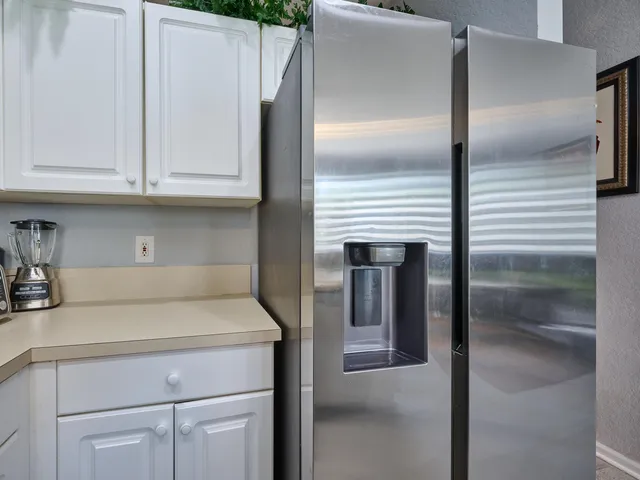 a bed room with a bed and a painting on the wall