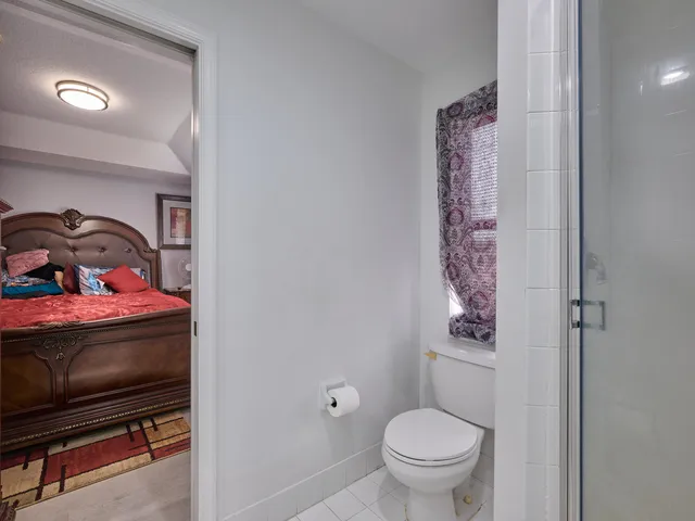 a view of yellow house with a large window and yard