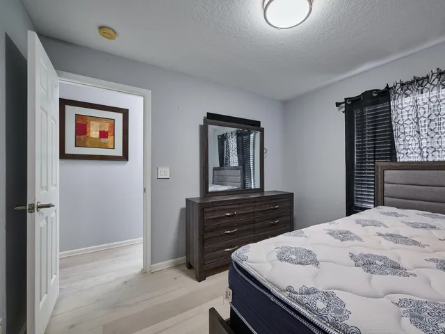 an aerial view of a house with a yard and lake