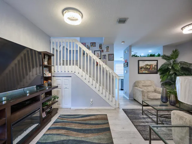 a living room with furniture and a lamp