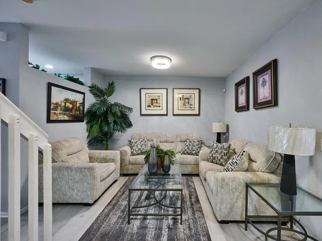 a kitchen with a sink stainless steel appliances and white cabinets