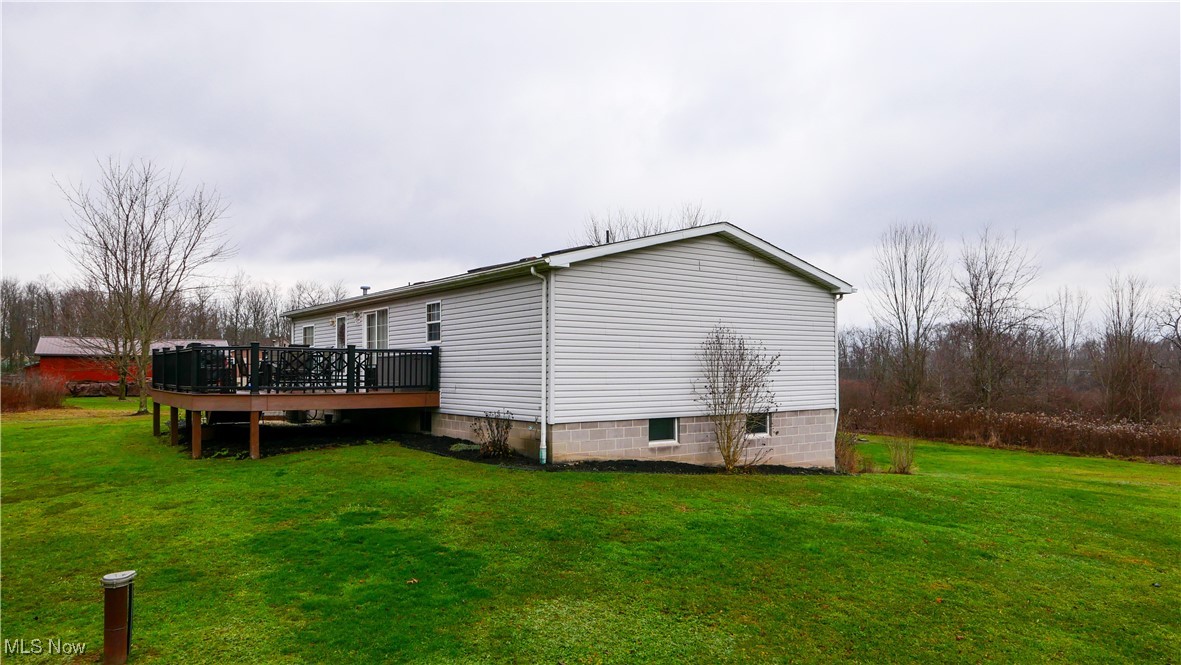 17296 Old State Road Middlefield, OH 44062 - Photo 35 of 44 View of side of property featuring a deck and a yard