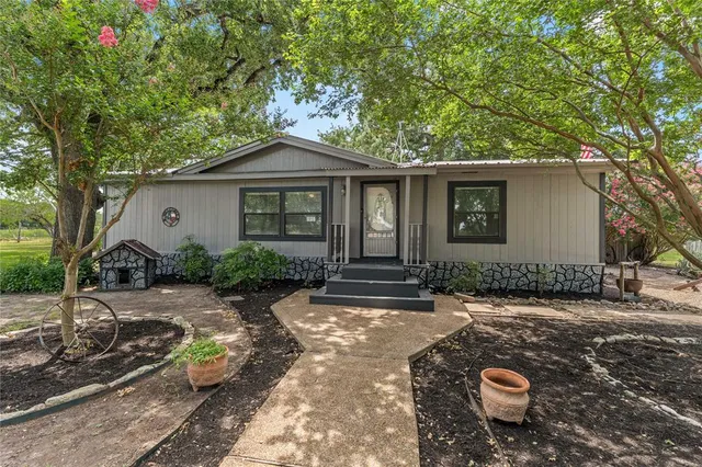 a backyard of a house with yard and outdoor seating