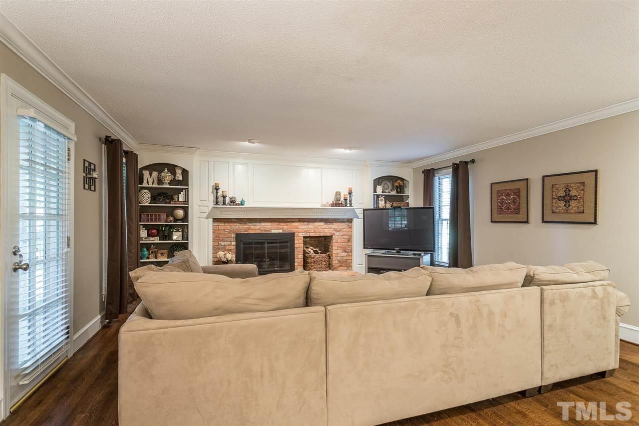 1025 Sawmill Road Raleigh, NC 27615 - Photo 13 of 25 a living room with furniture a fireplace and a large window