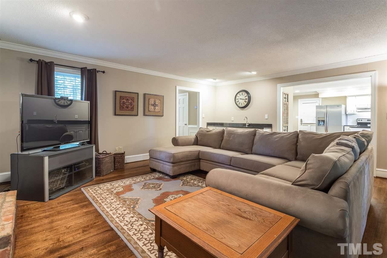 1025 Sawmill Road Raleigh, NC 27615 - Photo 16 of 25 a living room with furniture and a flat screen tv