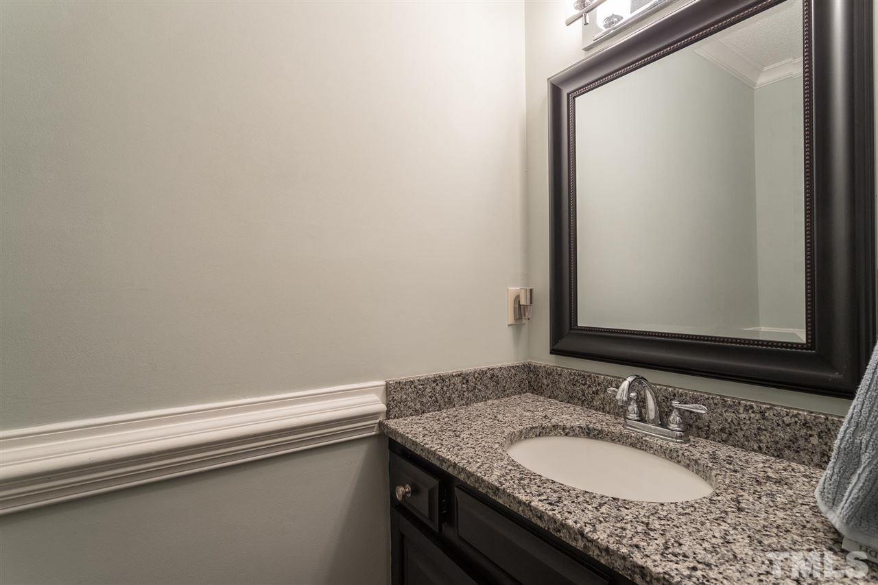 1025 Sawmill Road Raleigh, NC 27615 - Photo 17 of 25 a bathroom with a granite countertop sink and a mirror