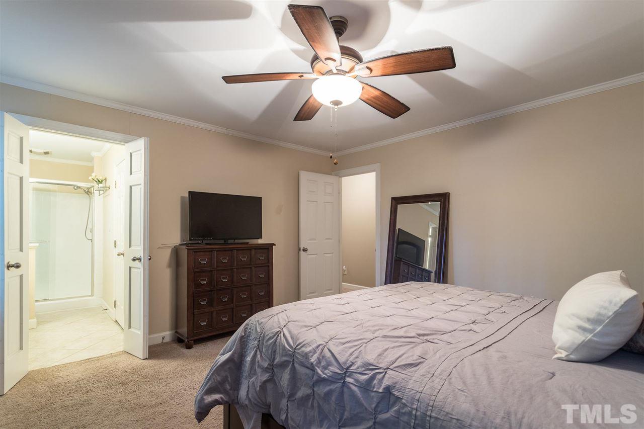 1025 Sawmill Road Raleigh, NC 27615 - Photo 19 of 25 a bedroom with a bed and a flat screen tv