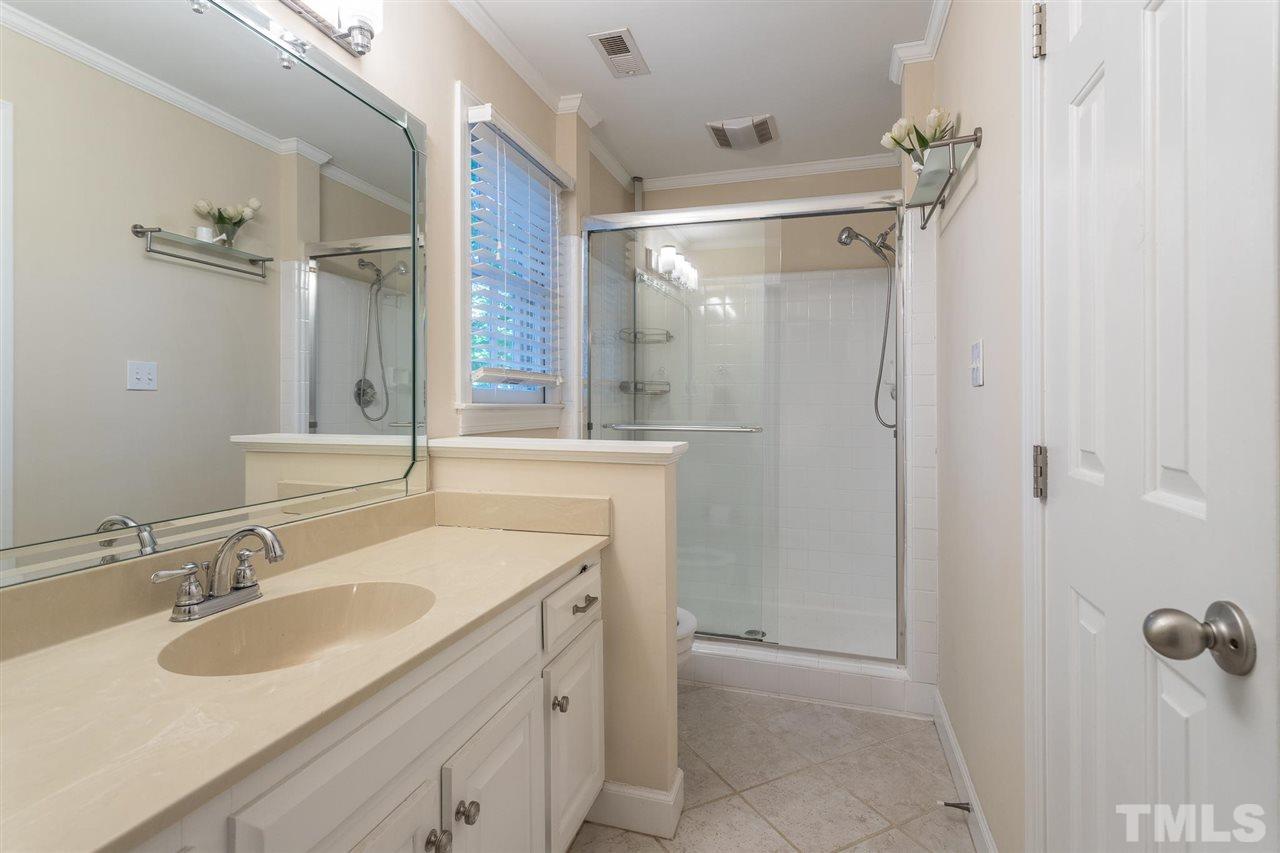 1025 Sawmill Road Raleigh, NC 27615 - Photo 20 of 25 a bathroom with a shower sink and mirror