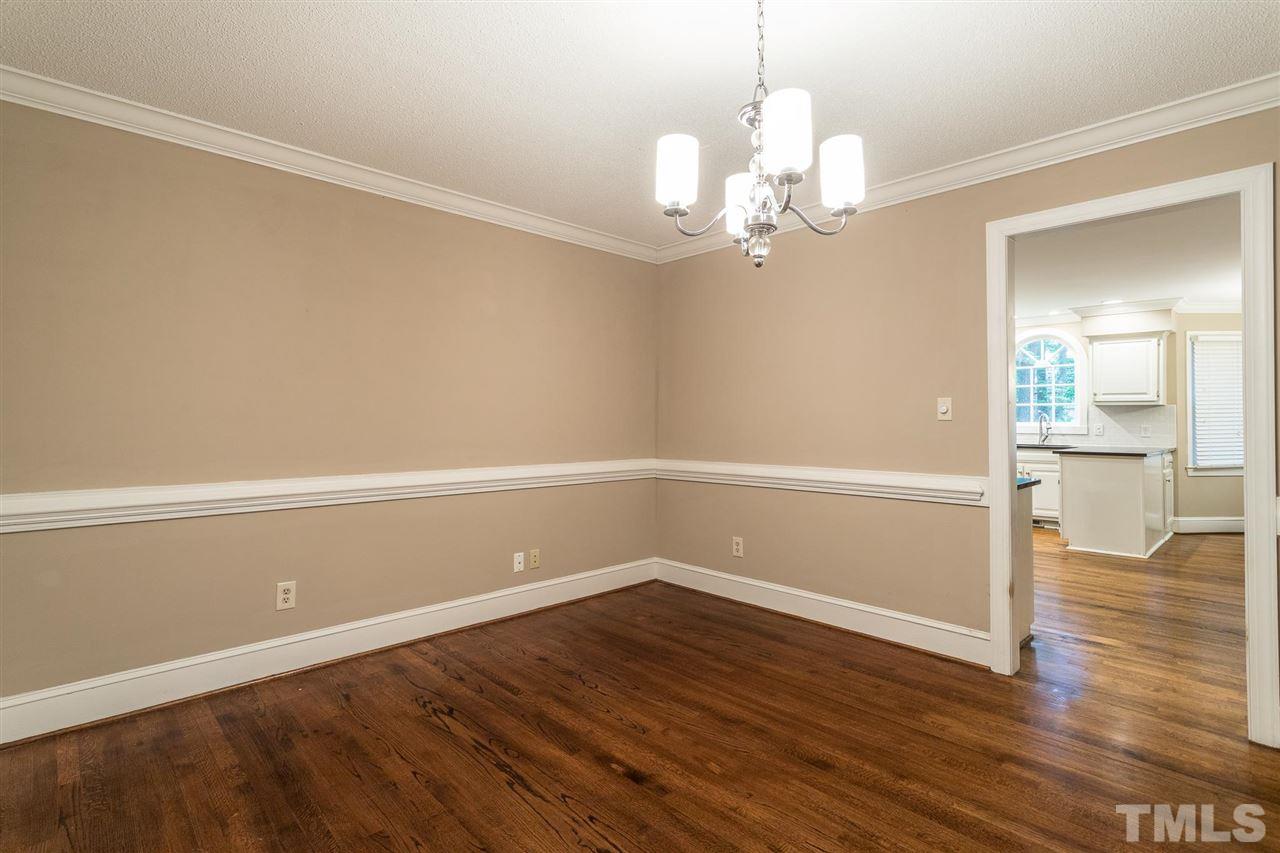 1025 Sawmill Road Raleigh, NC 27615 - Photo 3 of 25 a view of a room with wooden floor and chandelier