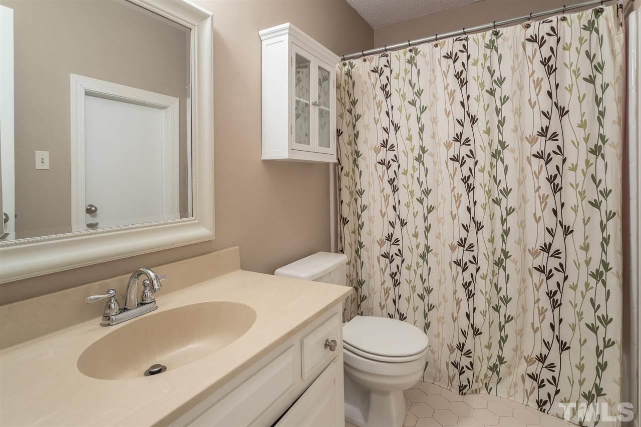 1025 Sawmill Road Raleigh, NC 27615 - Photo 22 of 25 a bathroom with a sink and a toilet