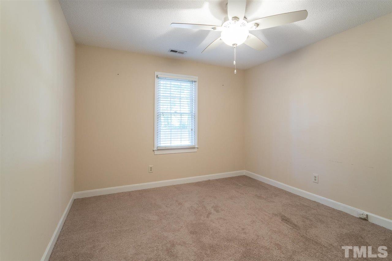 1025 Sawmill Road Raleigh, NC 27615 - Photo 23 of 25 an empty room with a window and a fan