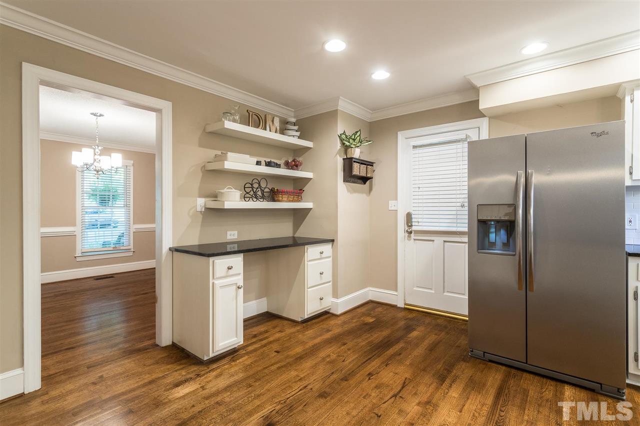 1025 Sawmill Road Raleigh, NC 27615 - Photo 5 of 25 a kitchen with stainless steel appliances a refrigerator and wooden floor