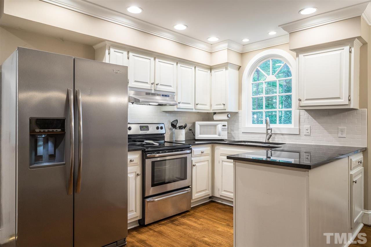 1025 Sawmill Road Raleigh, NC 27615 - Photo 6 of 25 a kitchen with stainless steel appliances granite countertop a stove a refrigerator and a sink