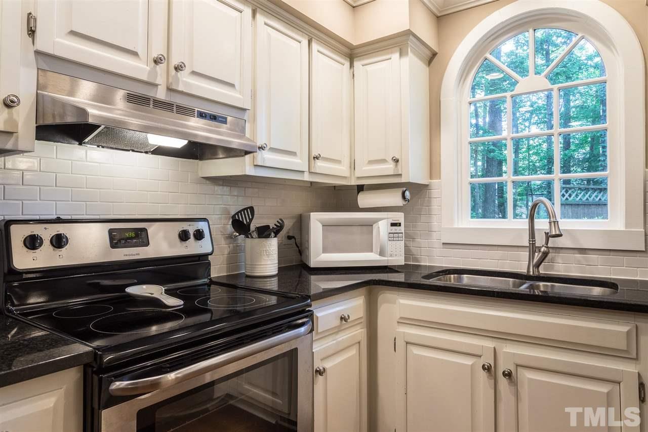 1025 Sawmill Road Raleigh, NC 27615 - Photo 7 of 25 a kitchen with a stove a sink and cabinets