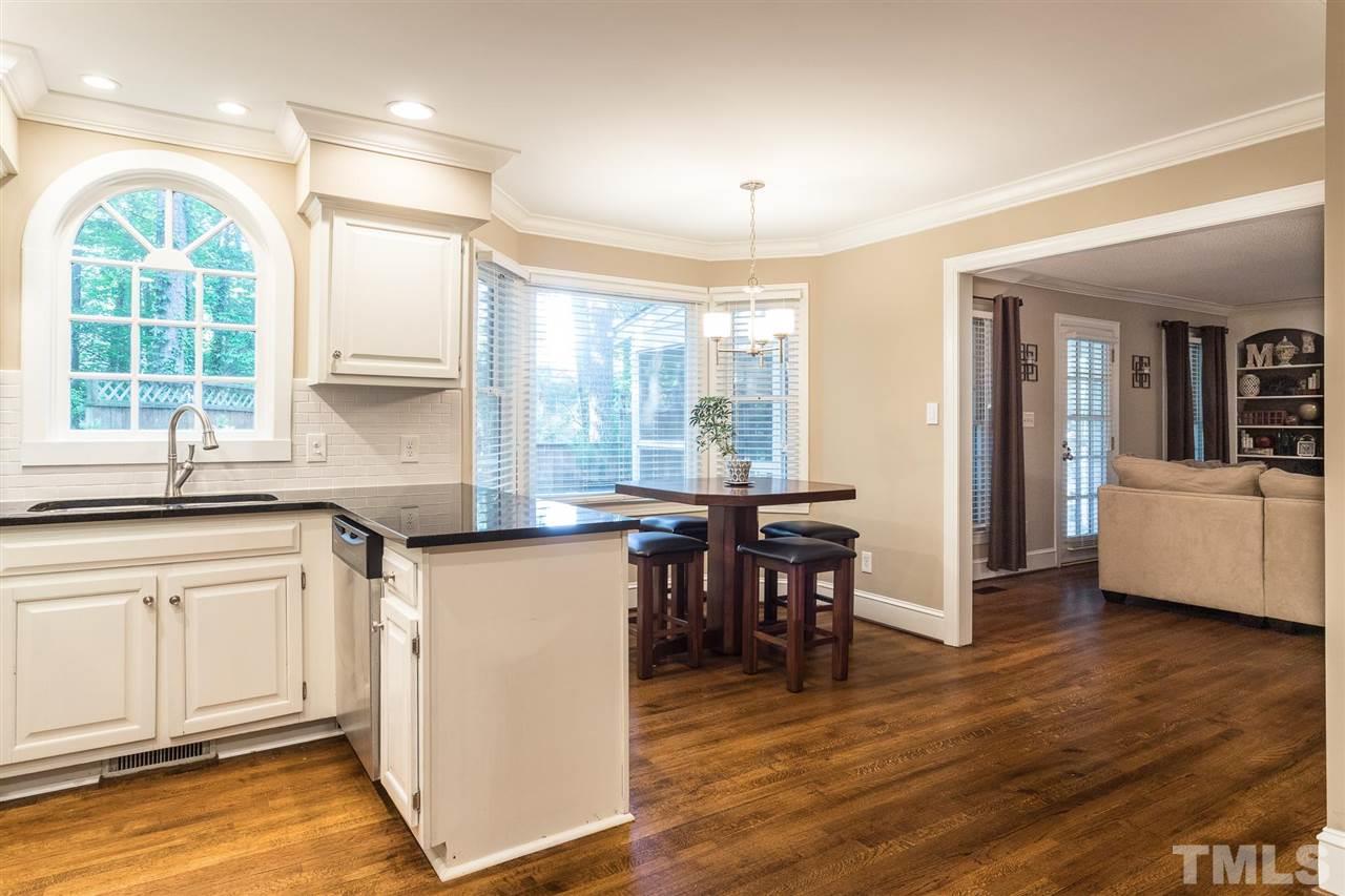 1025 Sawmill Road Raleigh, NC 27615 - Photo 8 of 25 a kitchen with stainless steel appliances granite countertop a stove a sink and a refrigerator