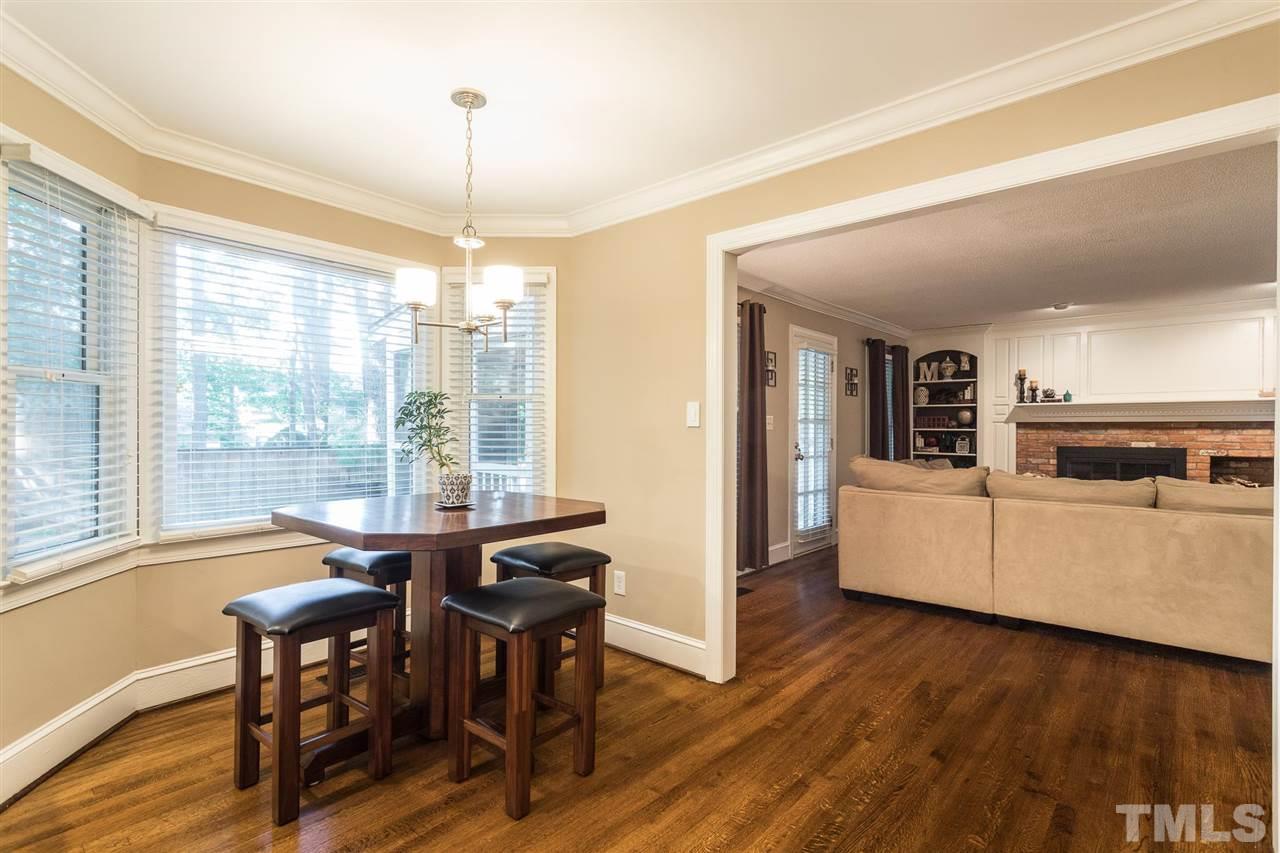 1025 Sawmill Road Raleigh, NC 27615 - Photo 9 of 25 a view of a dining room with furniture window and wooden floor