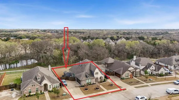 an aerial view of a house with a mountain