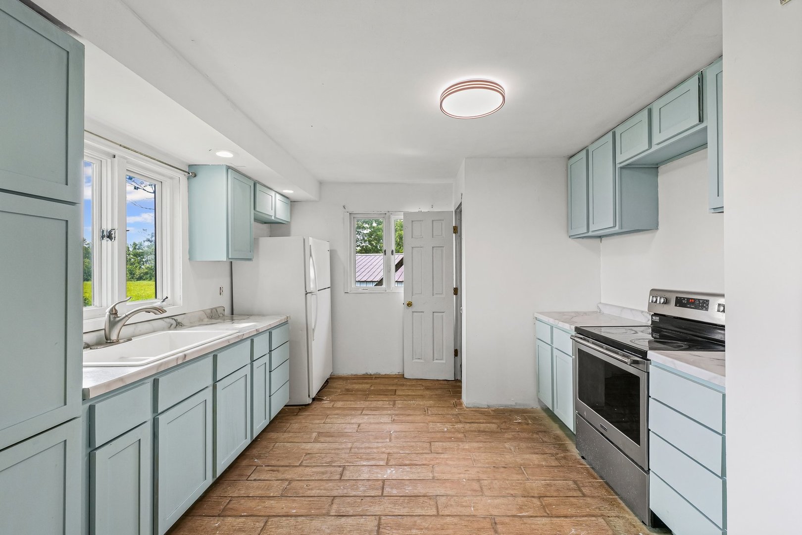 3609 Artesian Avenue Armstrong, IL 61812 - Photo 11 of 32 a kitchen with a sink stove and refrigerator