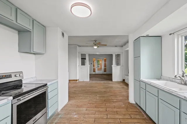 a kitchen with granite countertop a stove top oven and cabinets