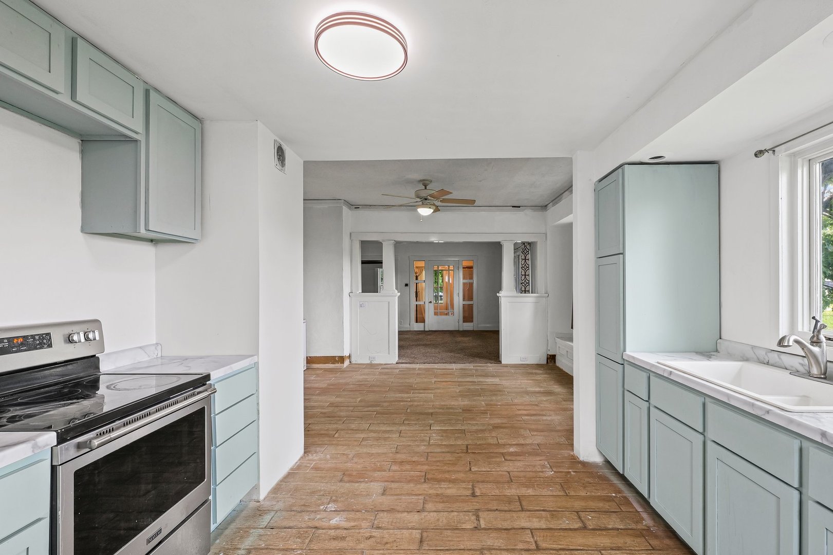 3609 Artesian Avenue Armstrong, IL 61812 - Photo 15 of 32 a kitchen with granite countertop a stove top oven and cabinets