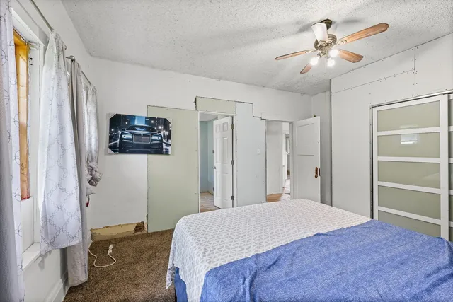 a bedroom with a bed and a chandelier