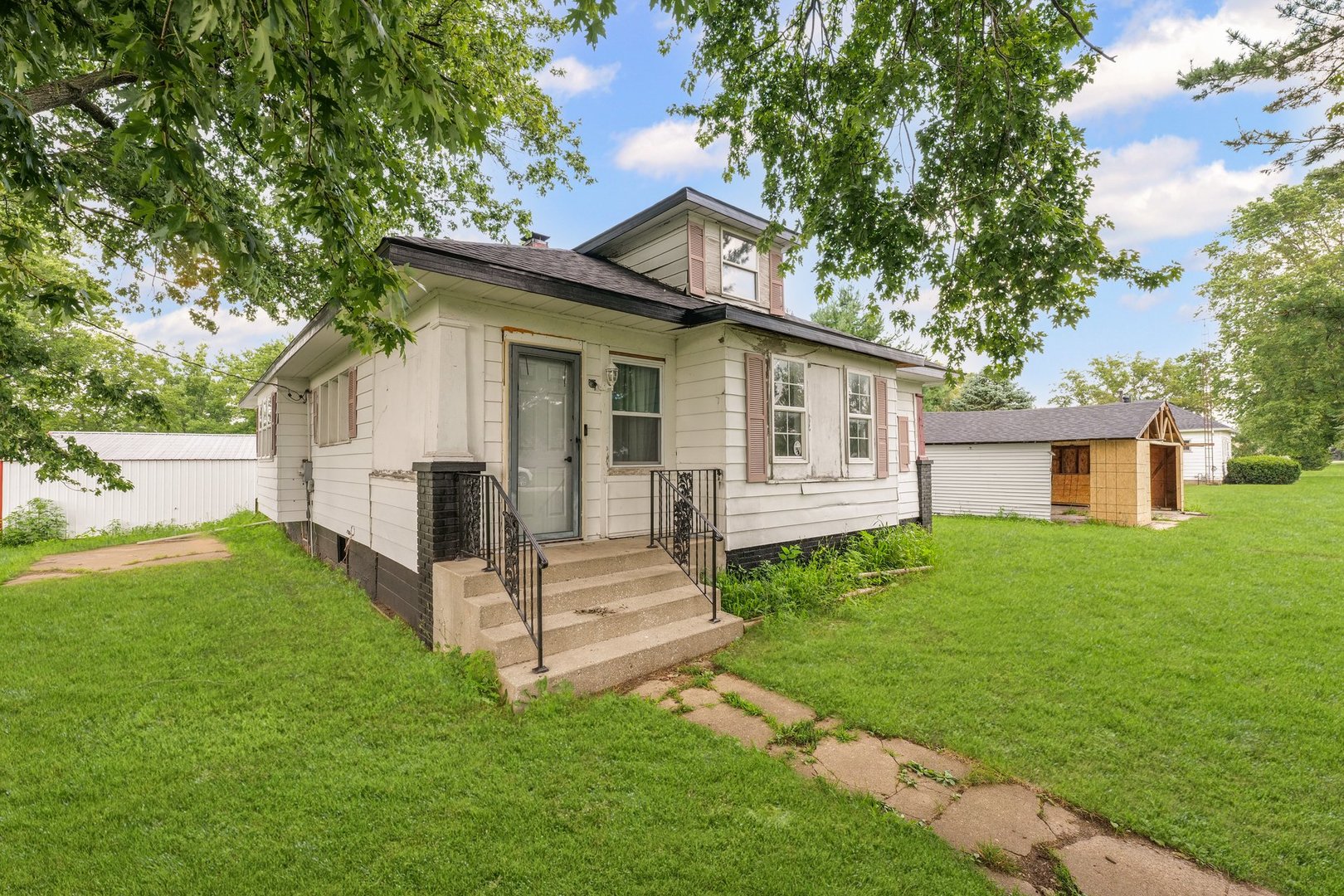 3609 Artesian Avenue Armstrong, IL 61812 - Photo 2 of 32 a view of a white house with a big yard and large trees