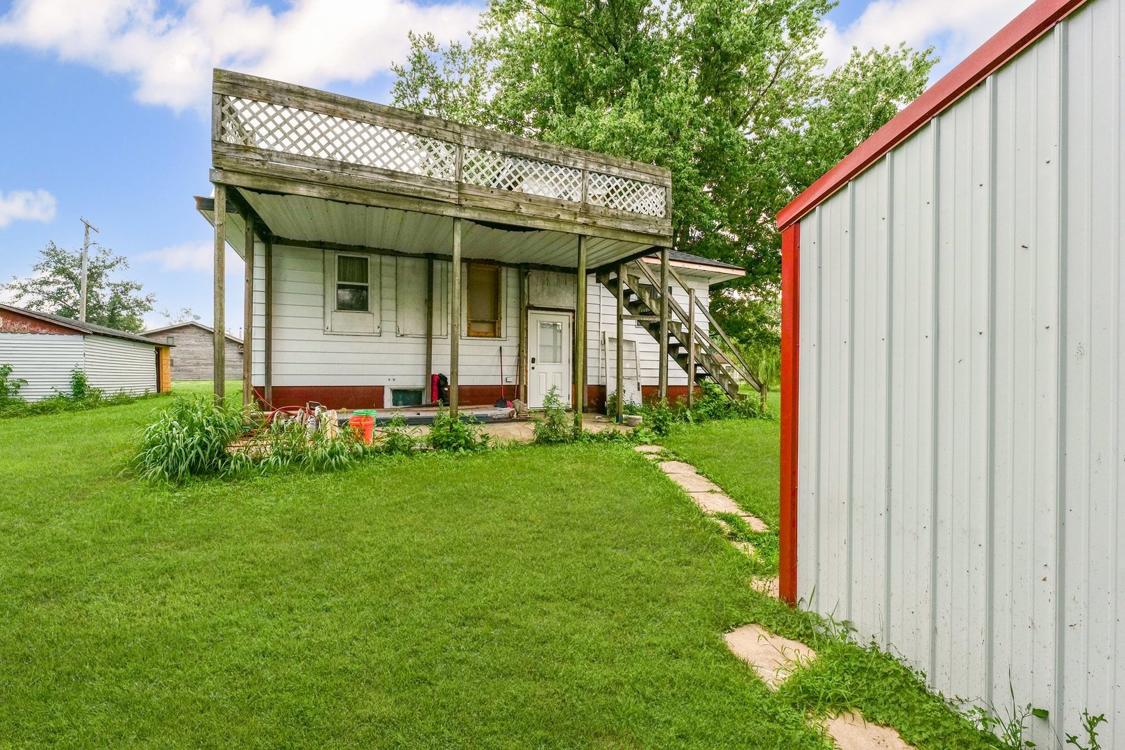 3609 Artesian Avenue Armstrong, IL 61812 - Photo 28 of 32 a view of a house with a yard plants and a chair