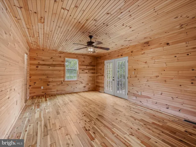 a view of a balcony with wooden floor and fence