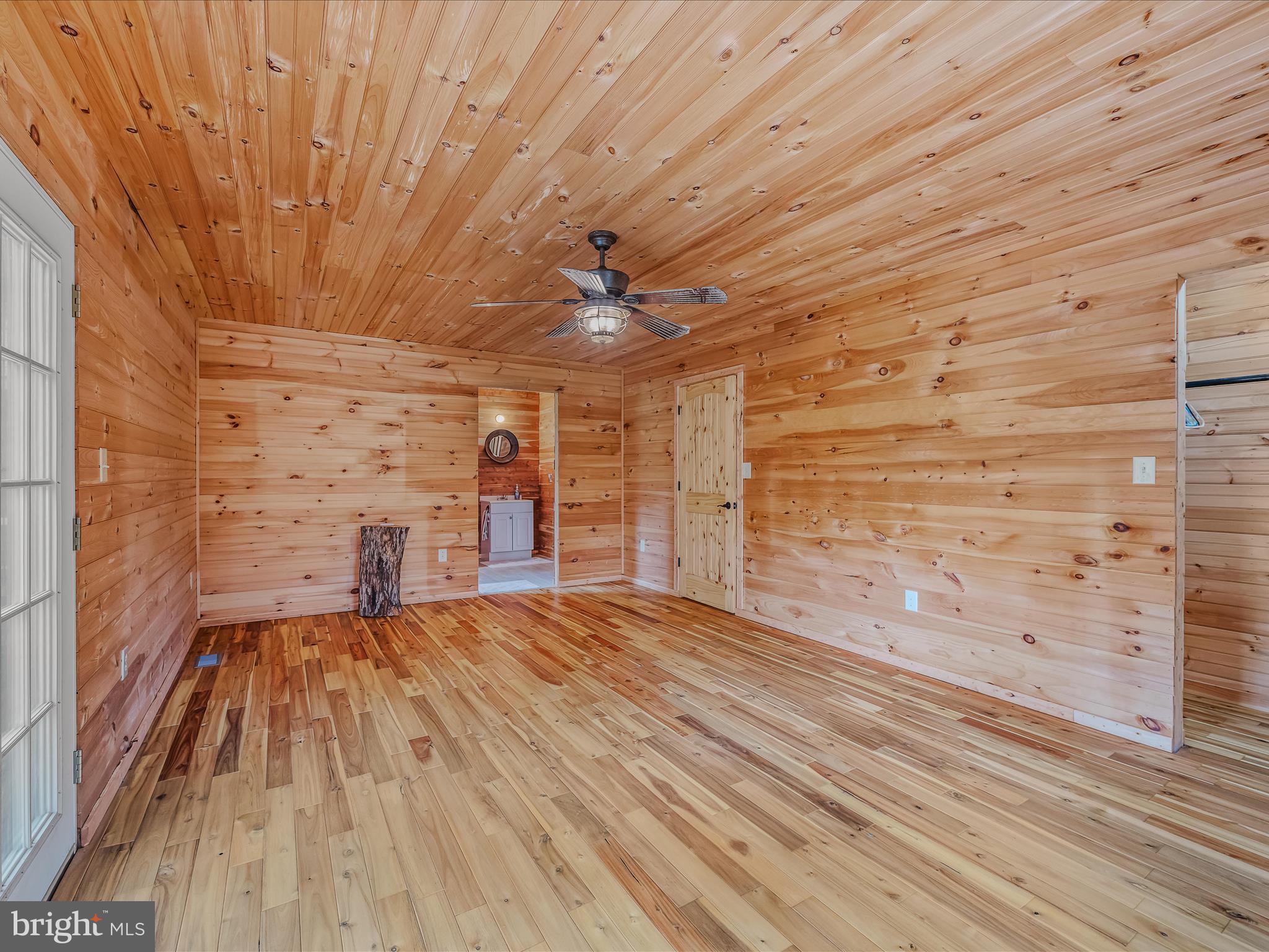 79 Whiskey Still Road Berkeley Springs, WV 25411 - Photo 23 of 59 a view of empty room with wooden floor