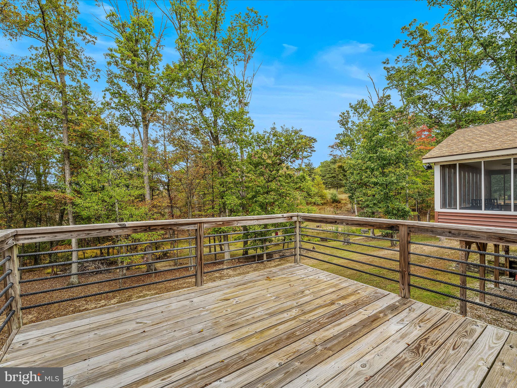 79 Whiskey Still Road Berkeley Springs, WV 25411 - Photo 25 of 59 a view of a balcony with wooden floor and fence