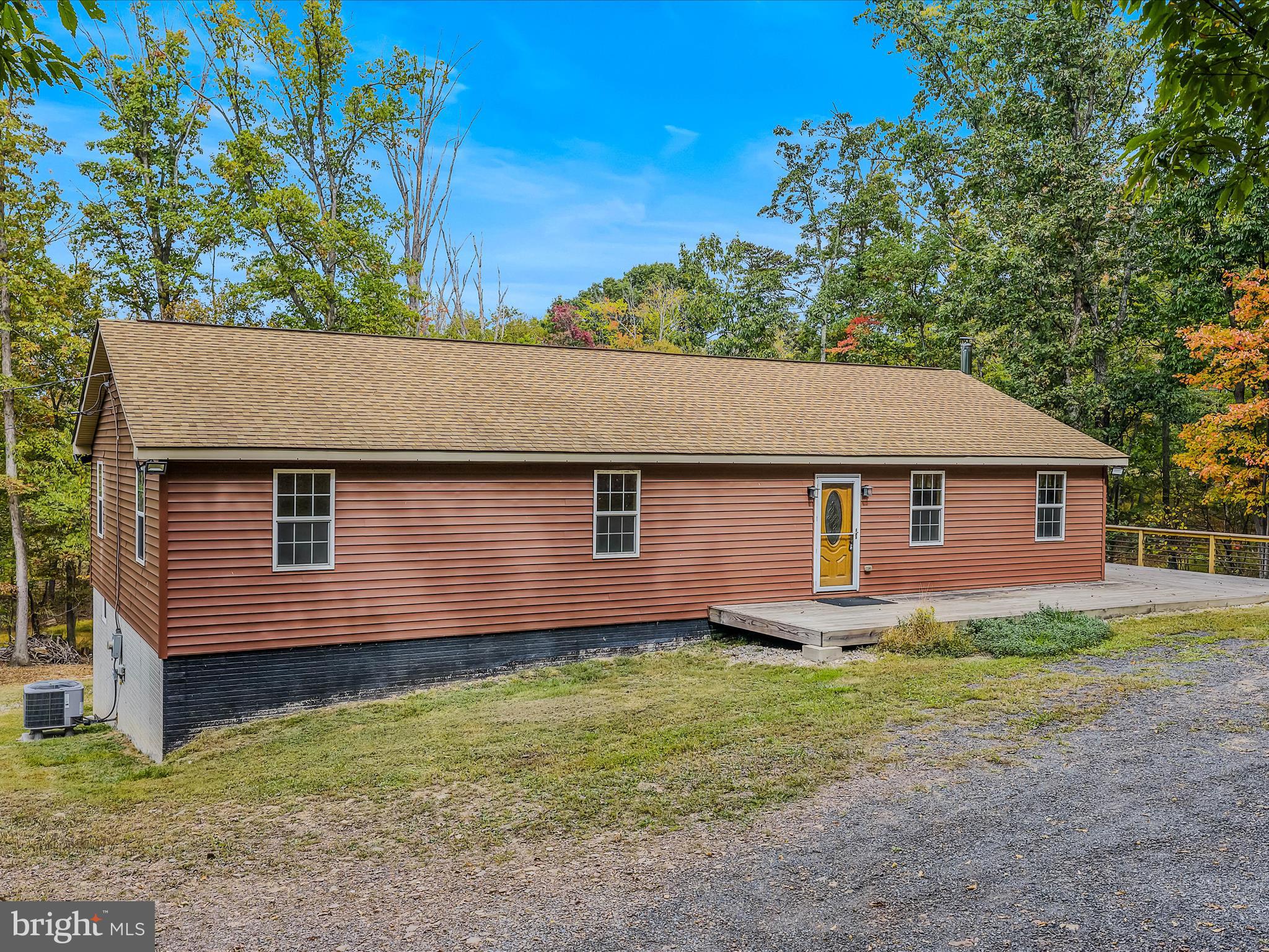 79 Whiskey Still Road Berkeley Springs, WV 25411 - Photo 3 of 59 a front view of a house with garden