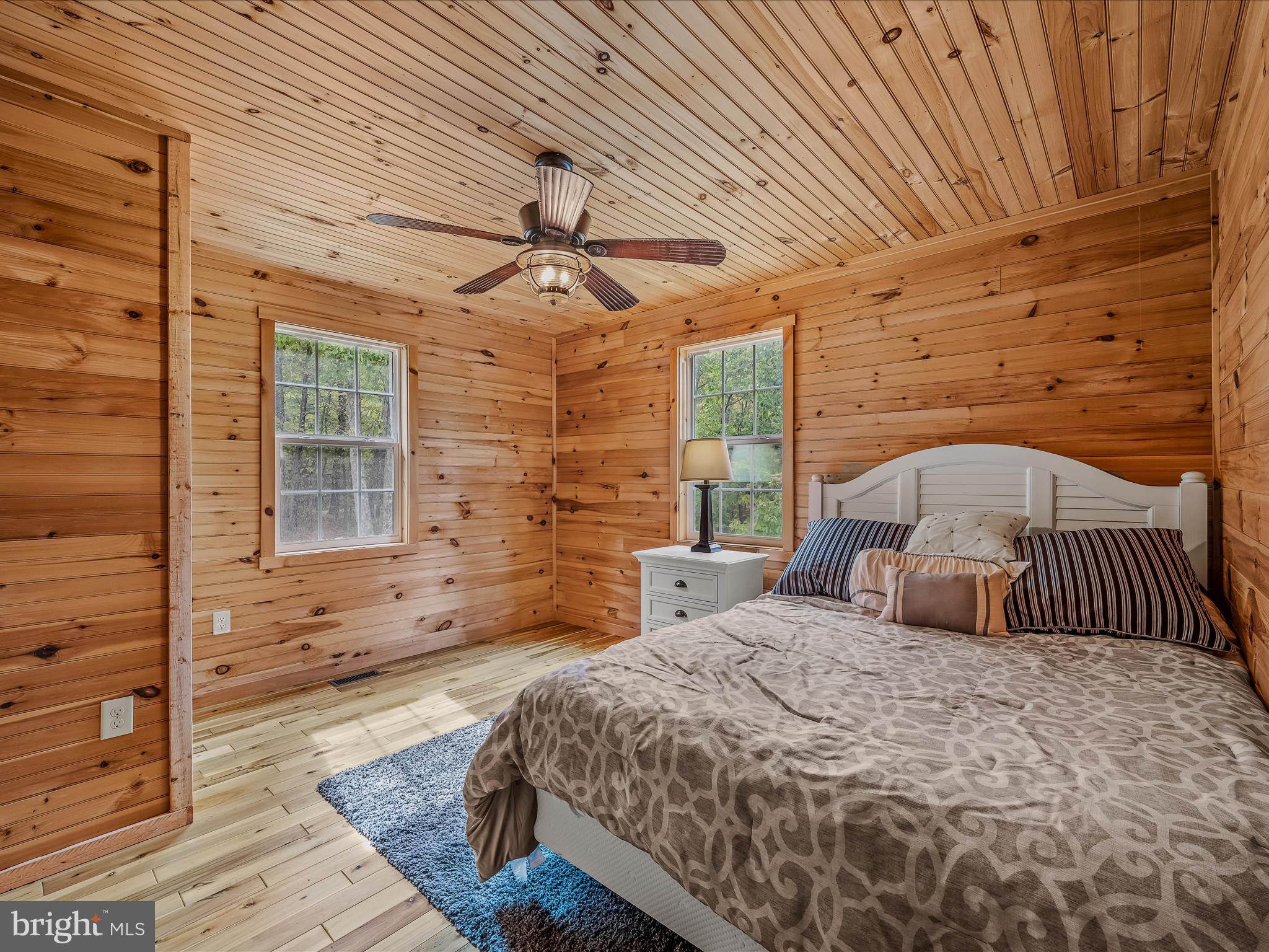 79 Whiskey Still Road Berkeley Springs, WV 25411 - Photo 32 of 59 a bedroom with a bed and a flat screen tv